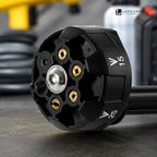 A close-up of a black LeFCart hose connector with gold-colored brass nozzles and white size markings (15 and 25) on a dark, blurred workshop background.