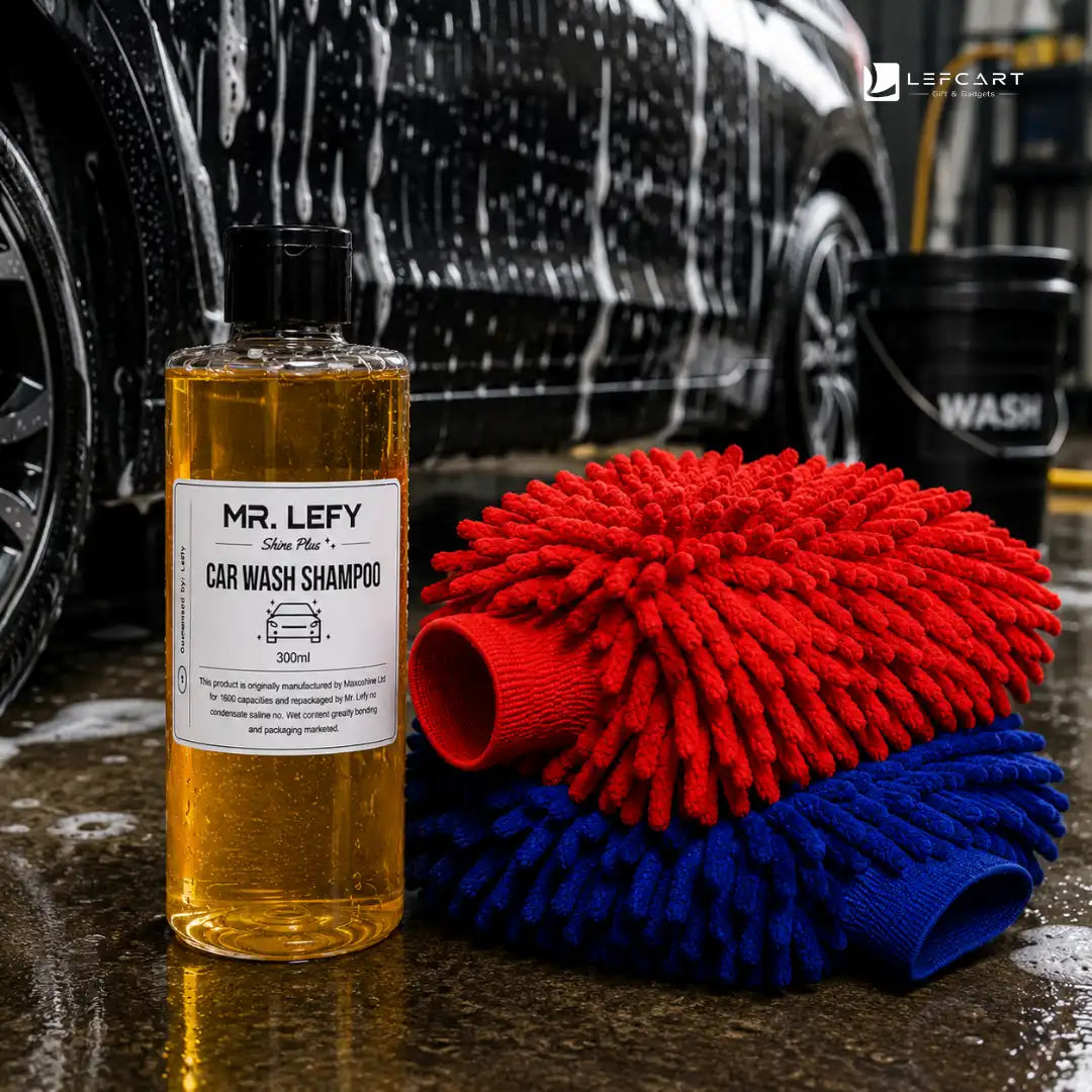 A bottle of Mr. Lefy Silver Mist Car Wash Shampoo stands next to two microfiber cleaning mitts, one red and one blue, in front of a wet car with soap foam in a garage setting.